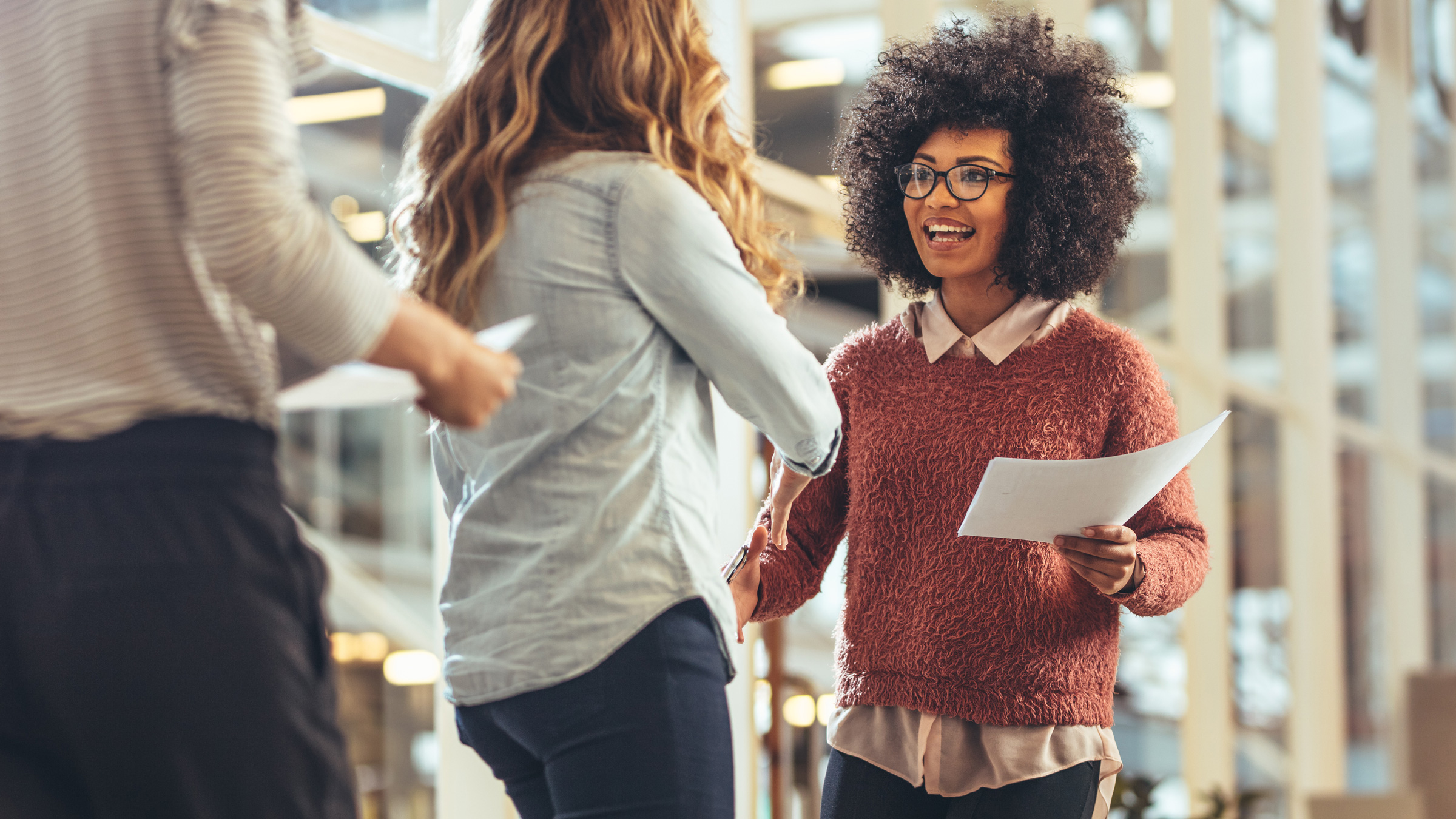 Smiling woman shaking a client's hand