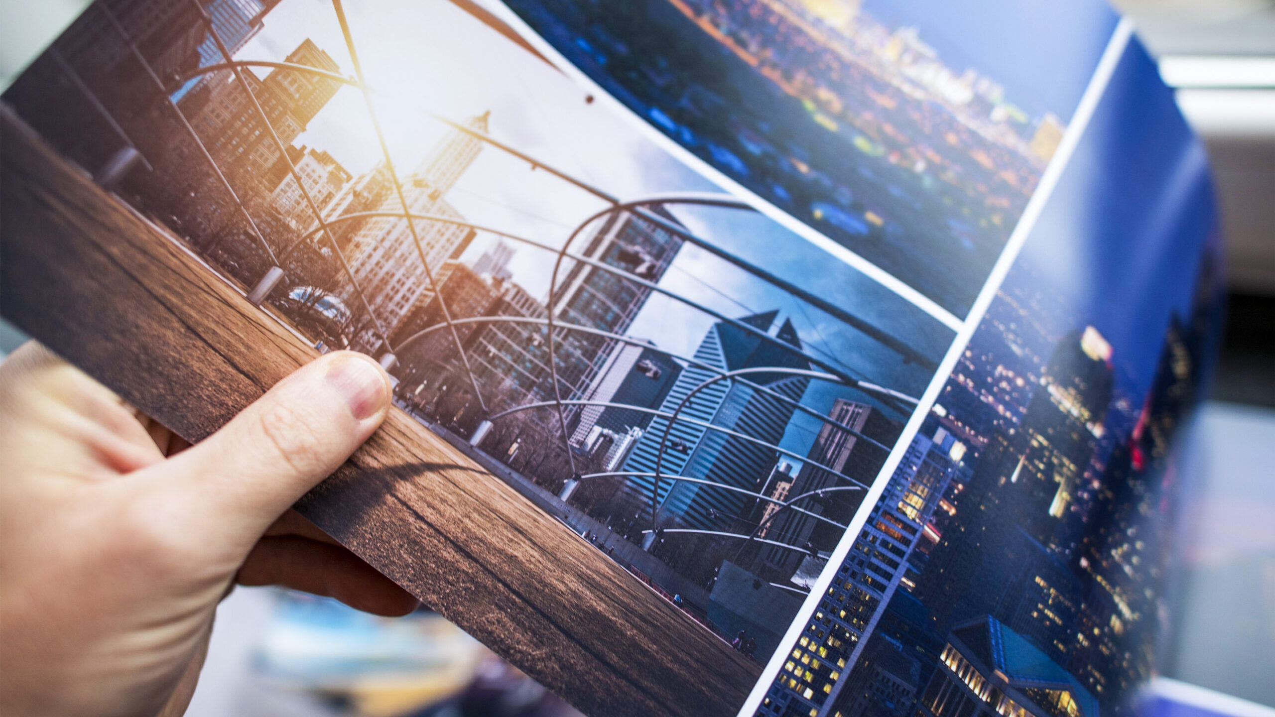 Close up of person looking at brochure with photos of buildings