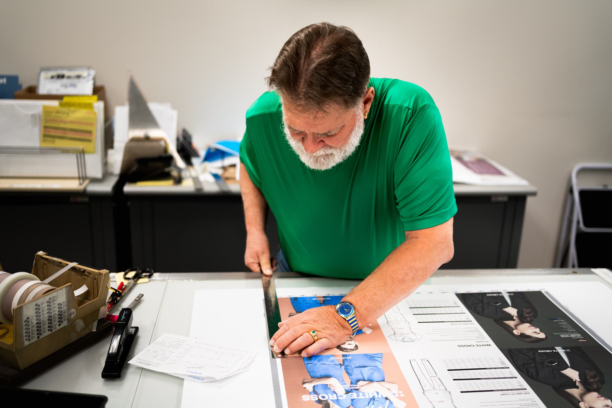 O'Neil employee trims a printed sheet