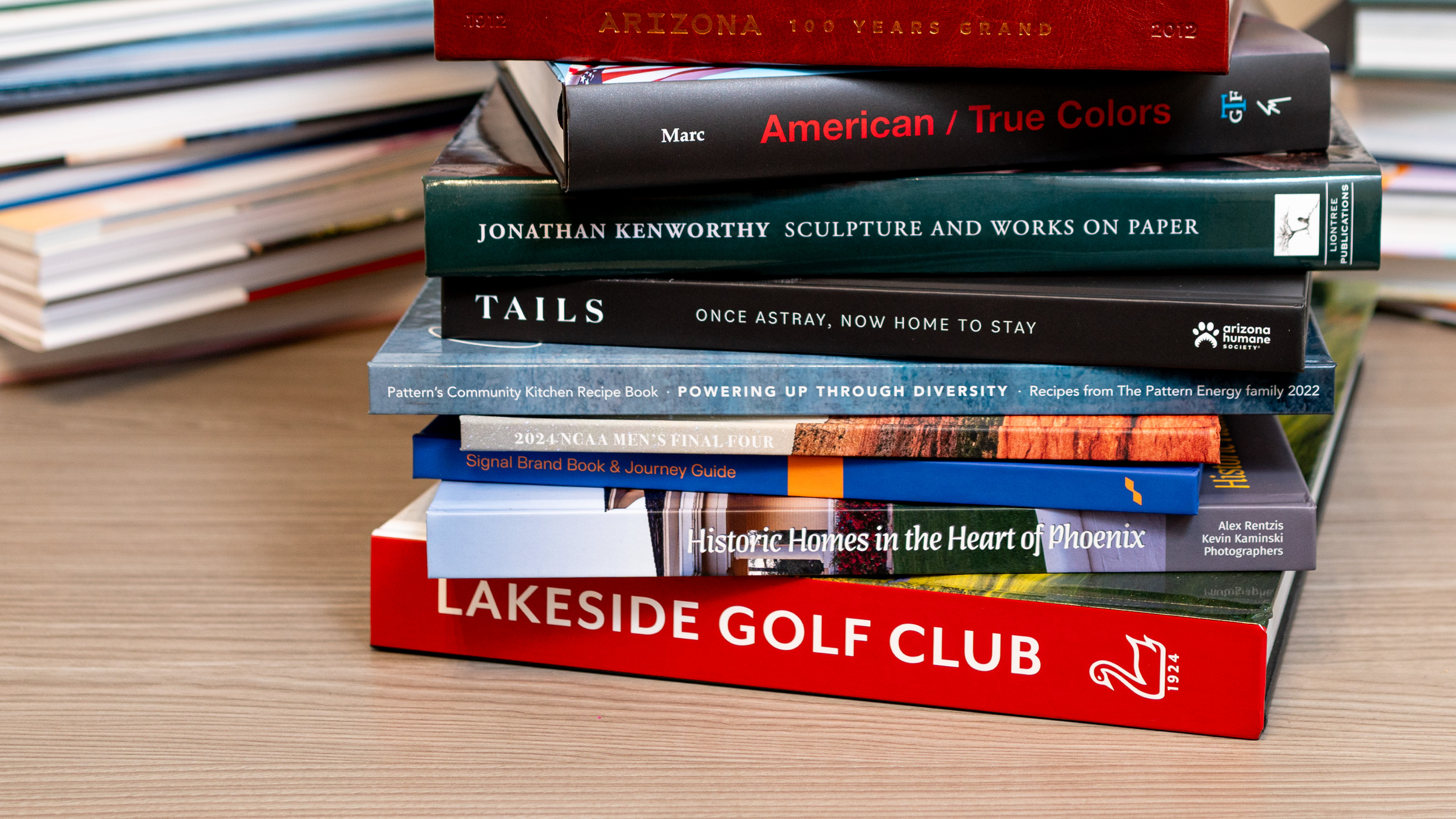 Stack of corporate books on a wood desktop