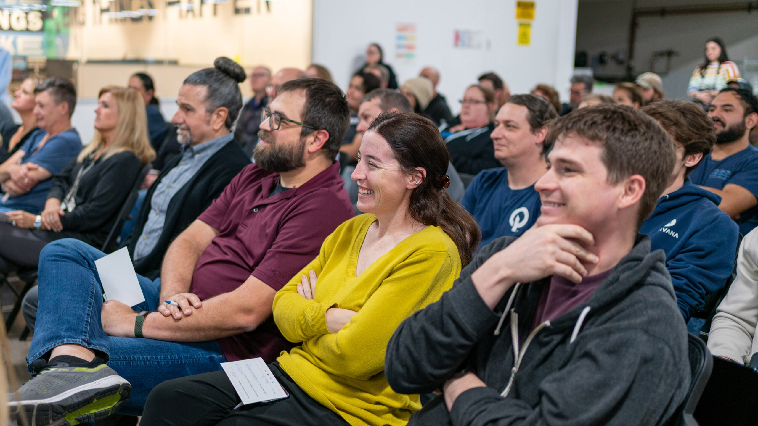 O'Neil employees sitting in the audience of a town hall meeting