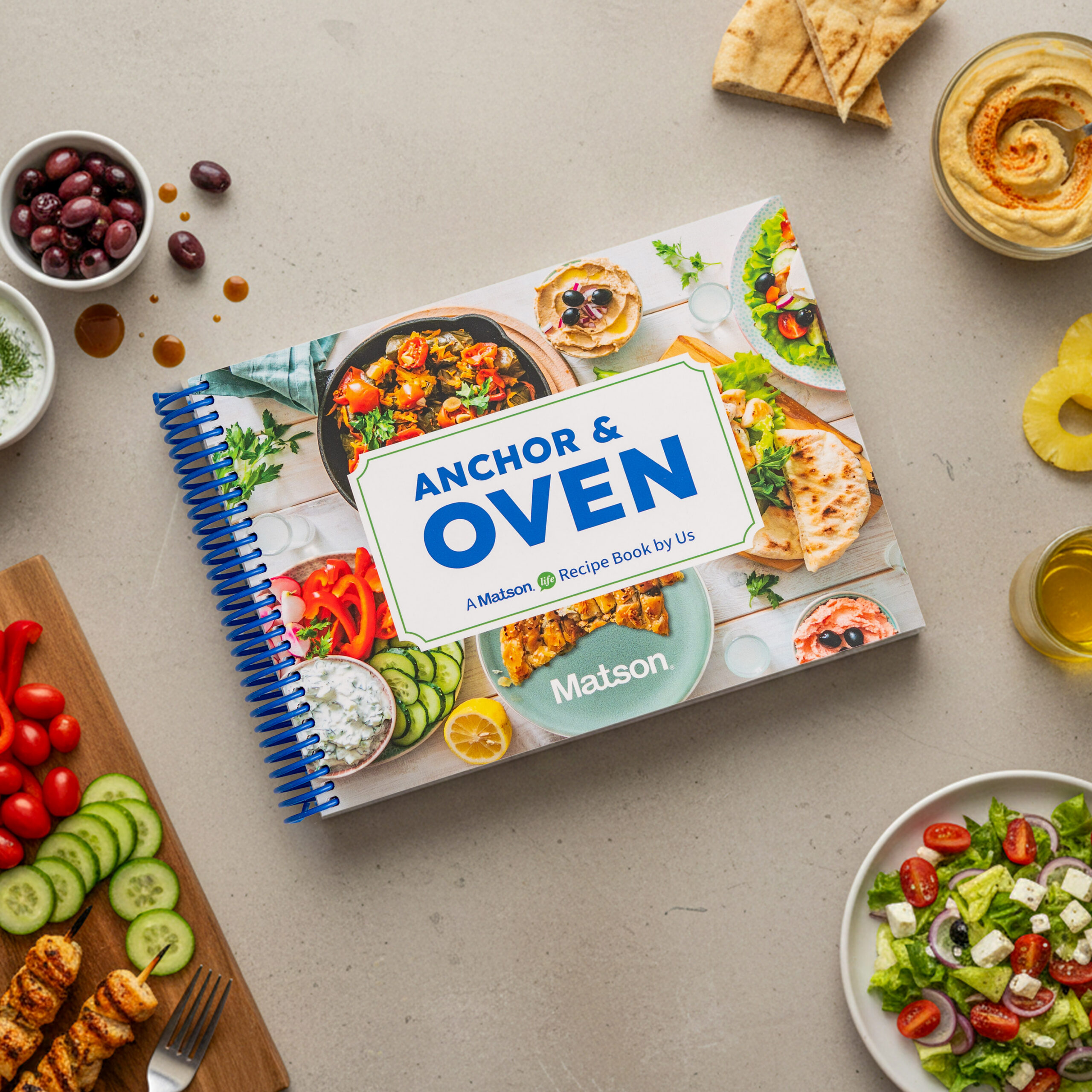 Cookbook cover surrounded by ingredients