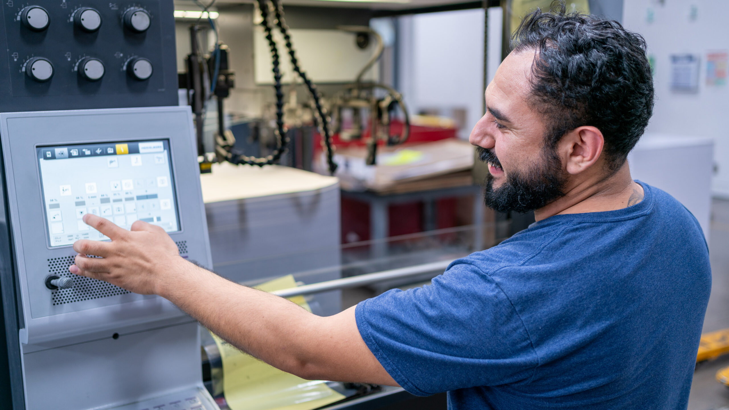 Employee controlling the press