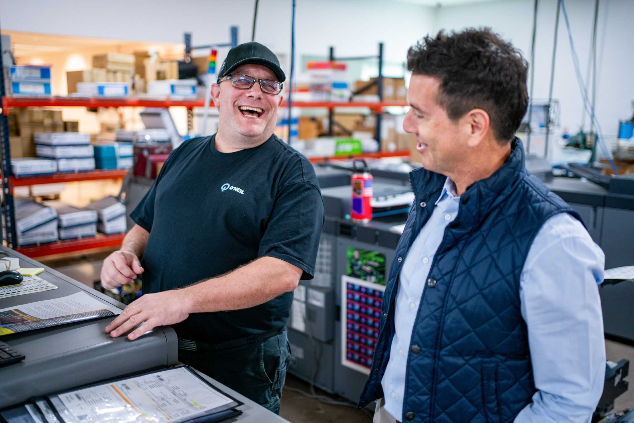 Employee laugh with Simon on the production floor