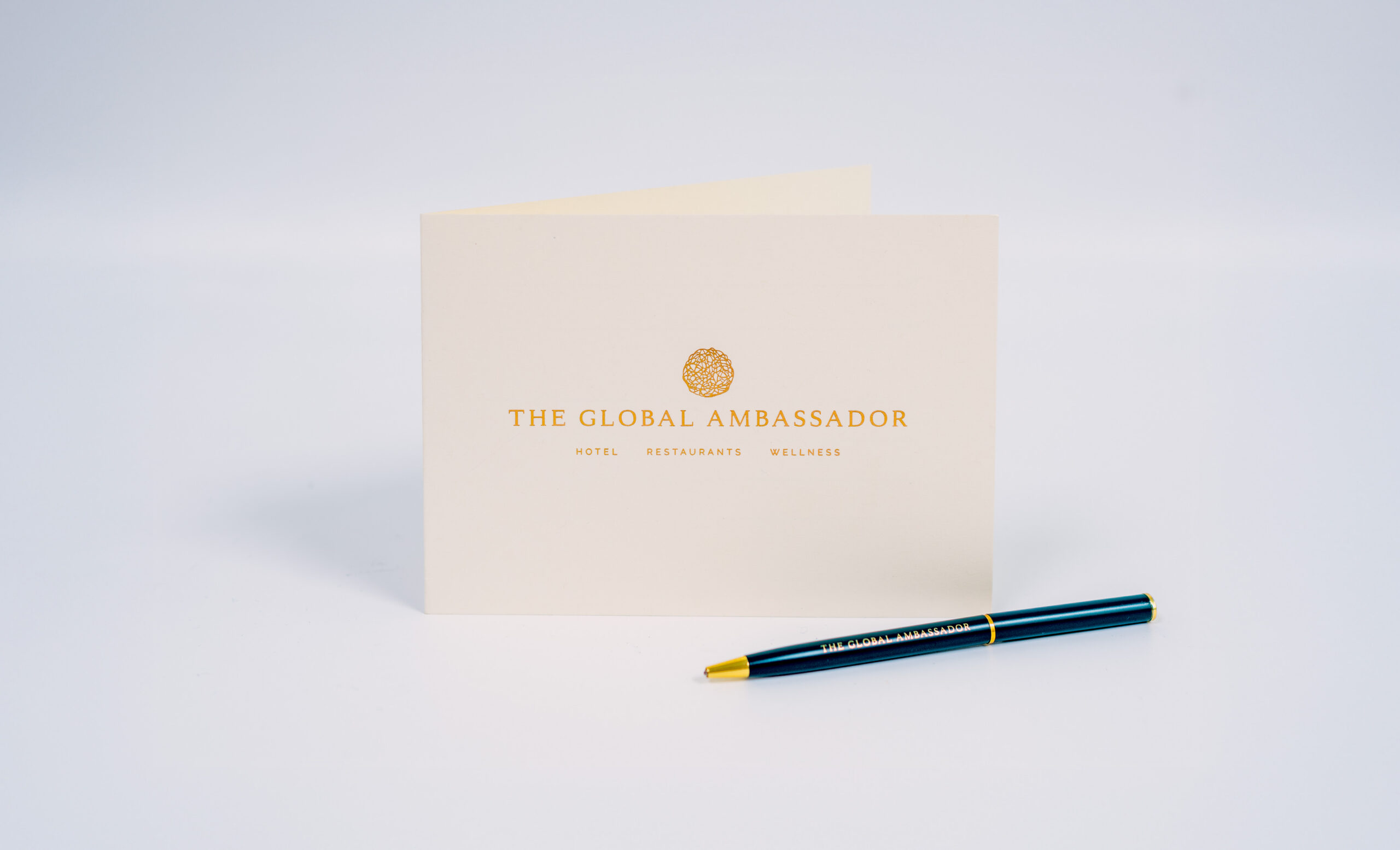 The Global Ambassador card with pen on a white background