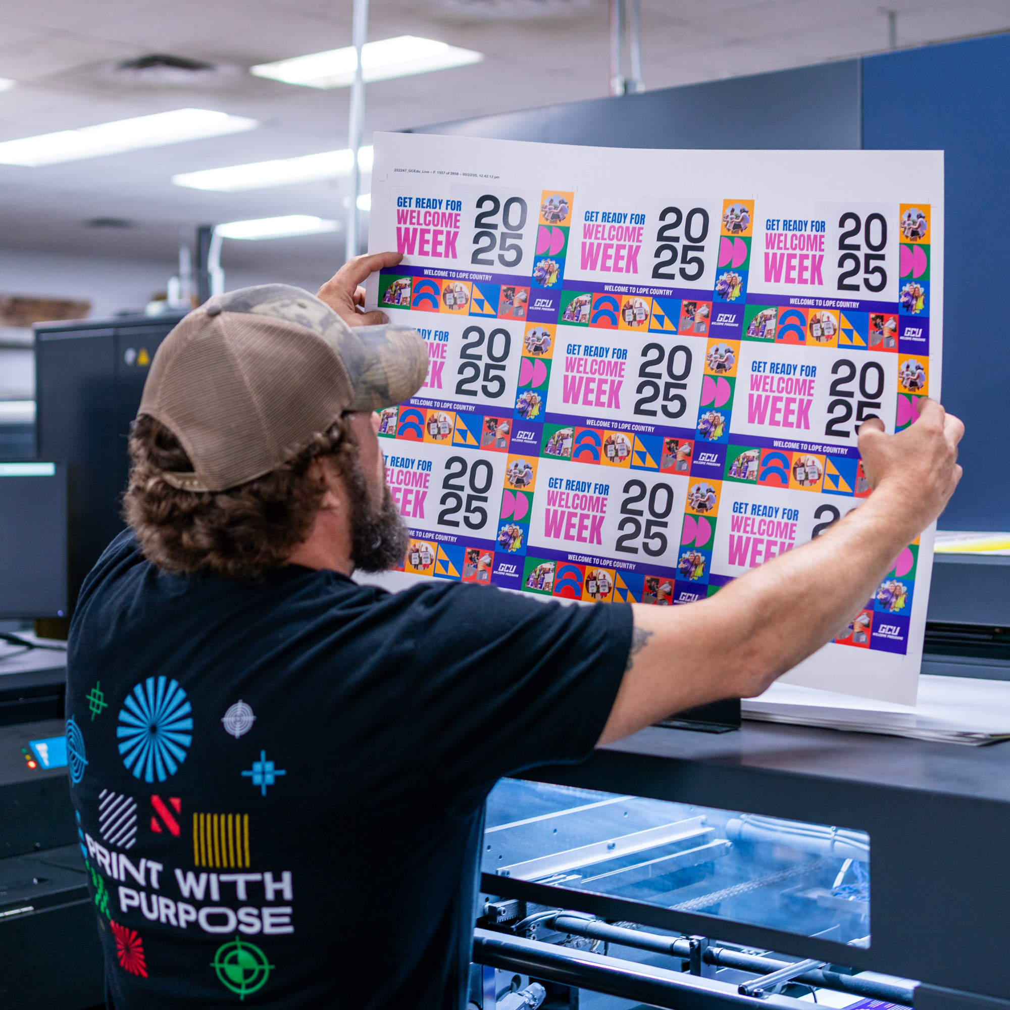 Production team member inspects a print sheet square