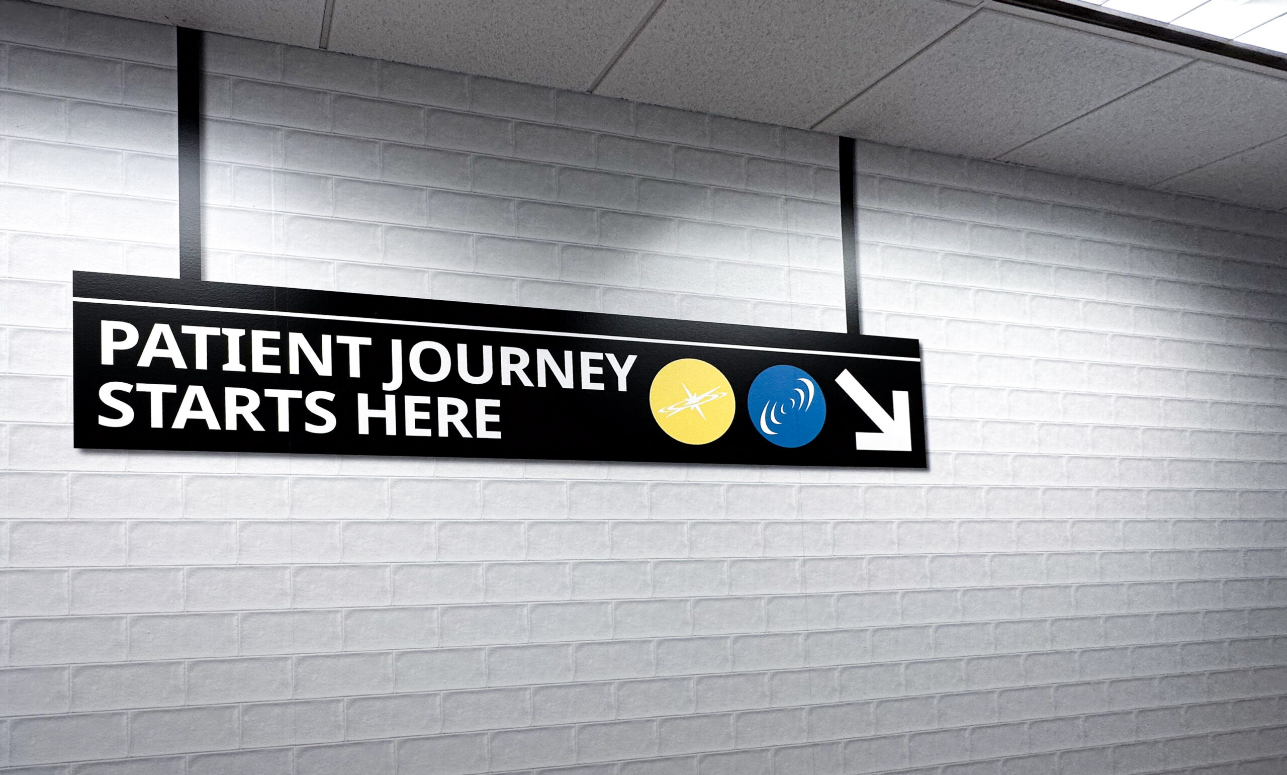 Wall graphics to mimic a subway sign on a white brick wall