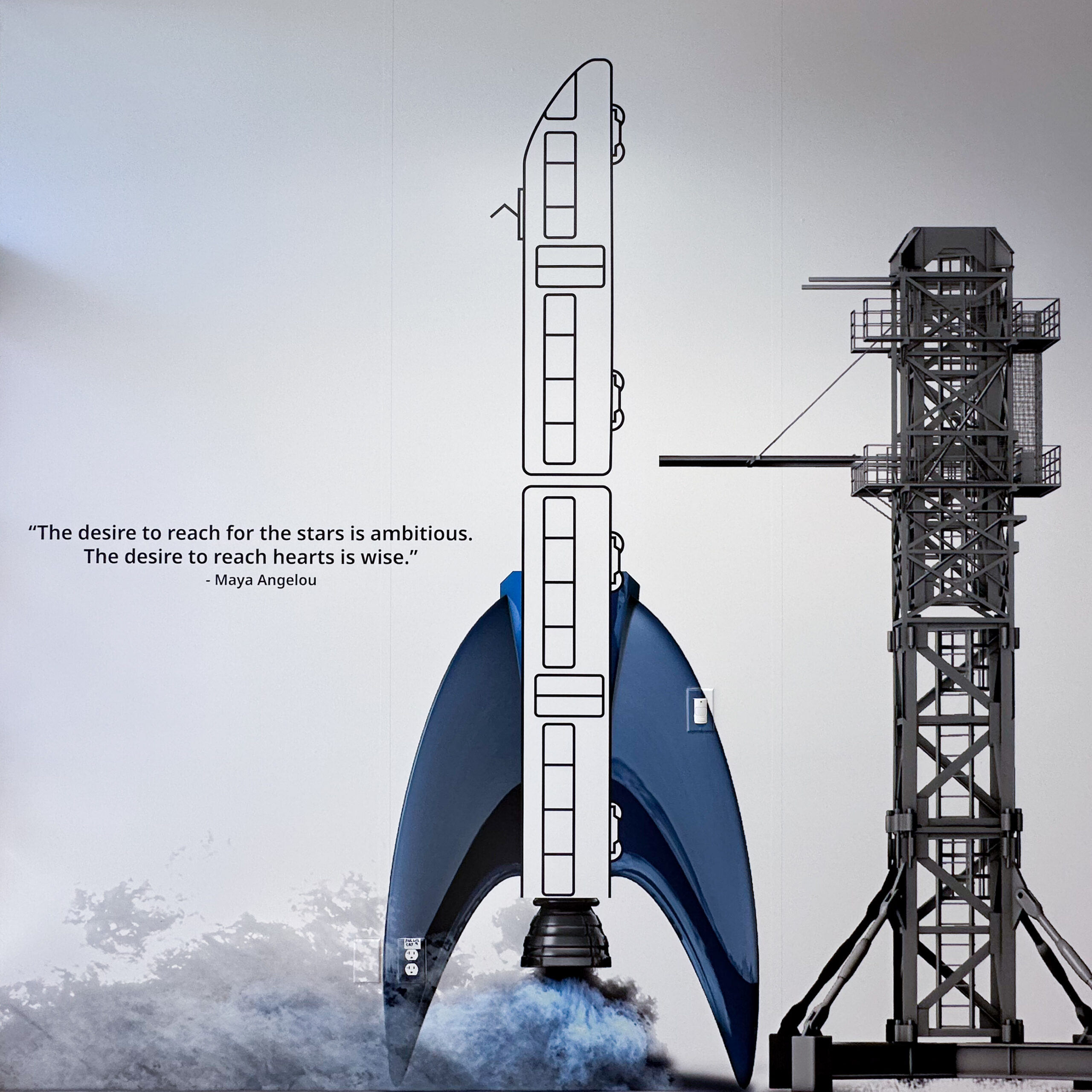 Maya Angelou quote alongside a wall graphic of a rocket ready for liftoff