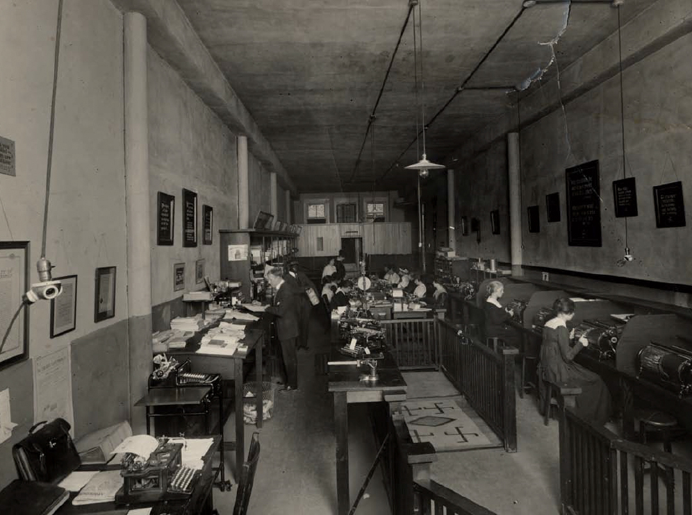 Black and white historical photo of O'Neil workers in the original print shop