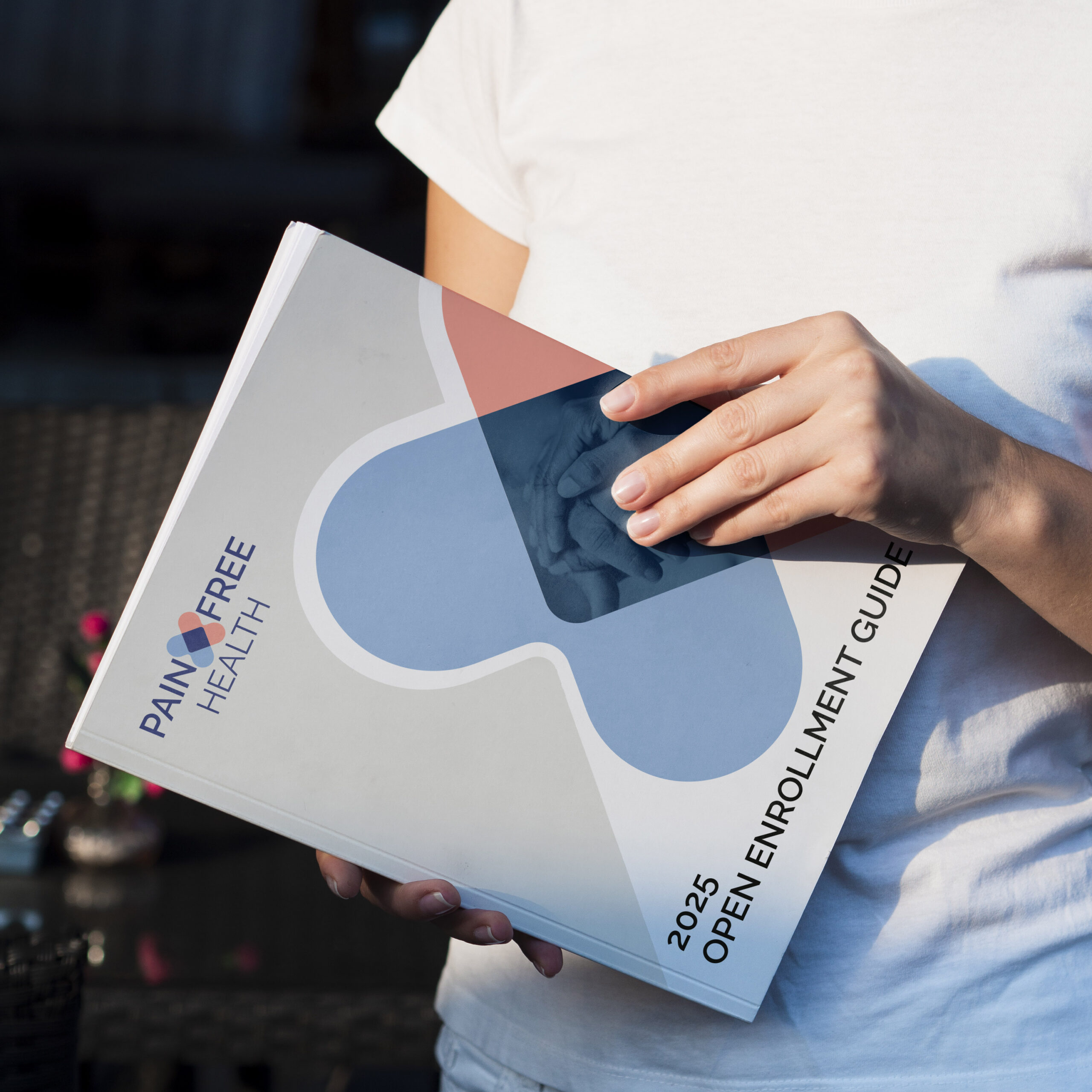 Closeup of a woman holding a Pain Free Enrollment brochure