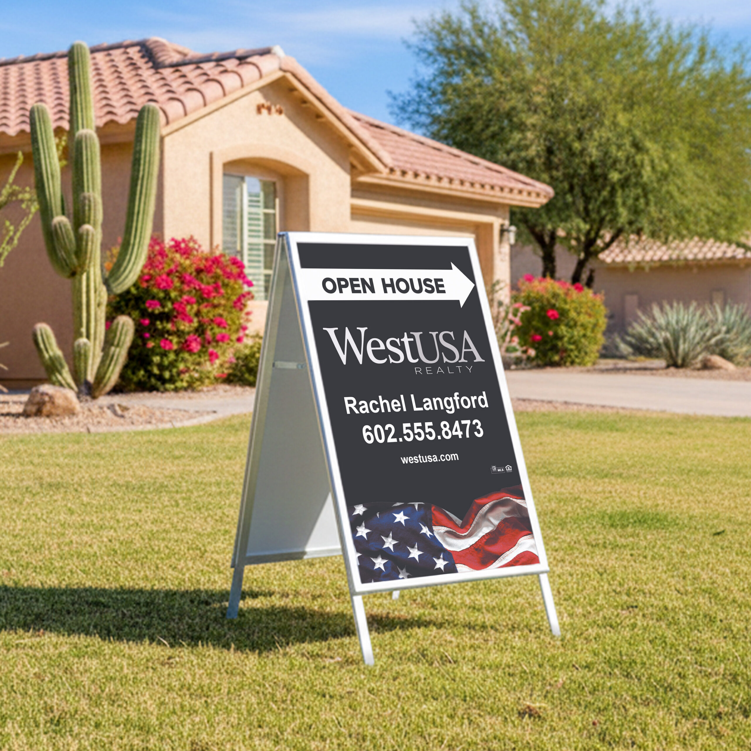 WestUSA Realty triangle stand banner in a yard in front of a southwest-style home