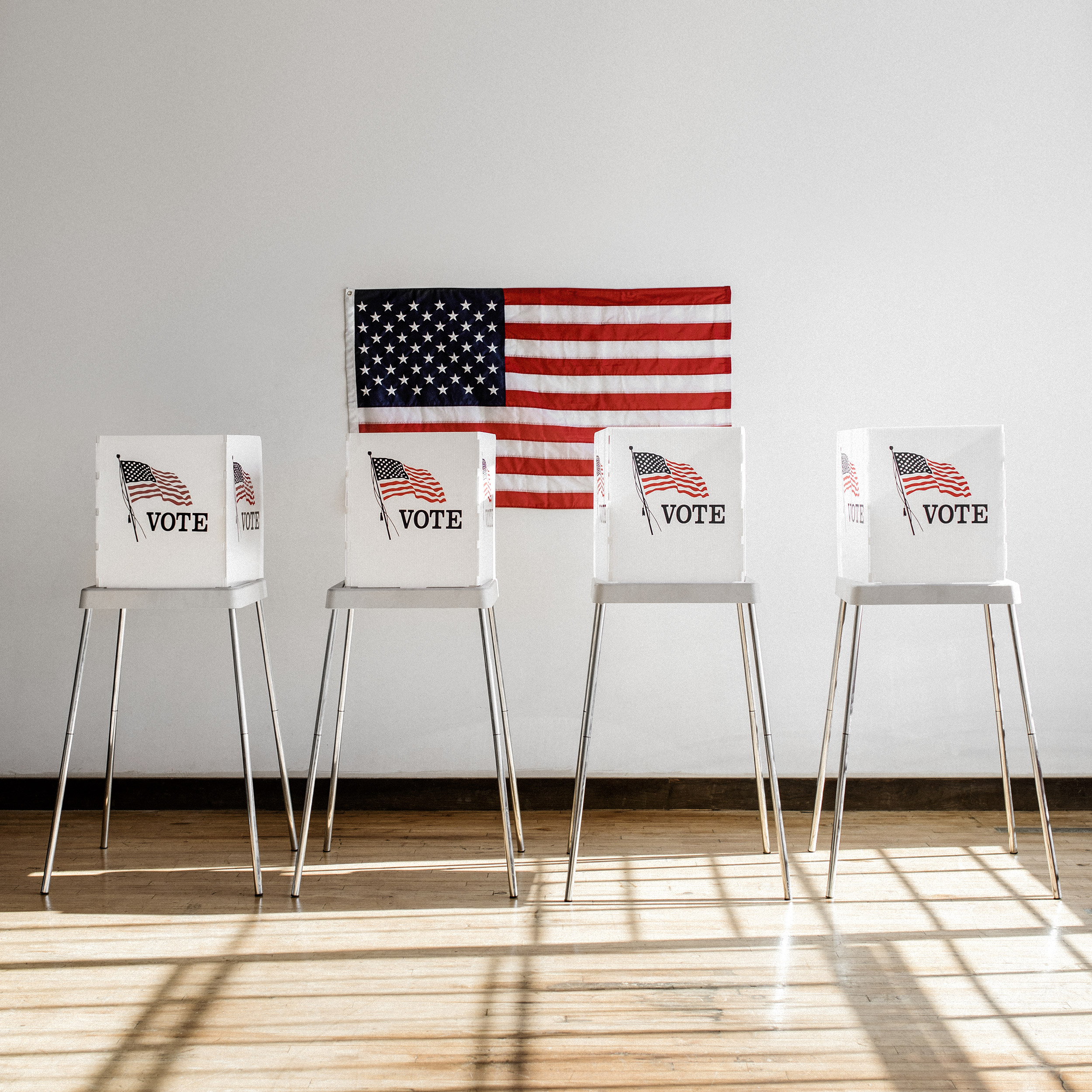 American polling booth lined up in front of the flag