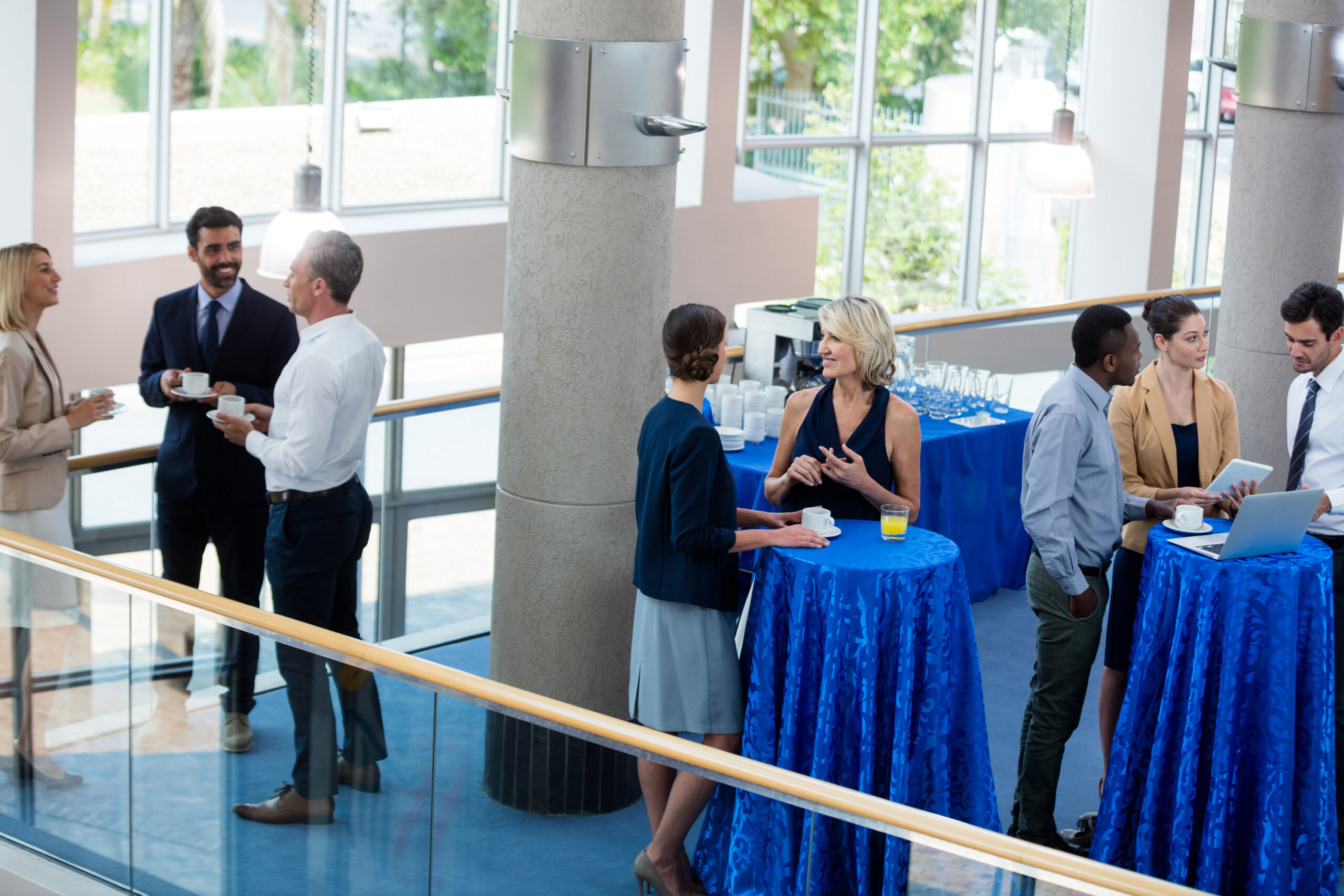 Business executives interacting with each other in a reception area at an event