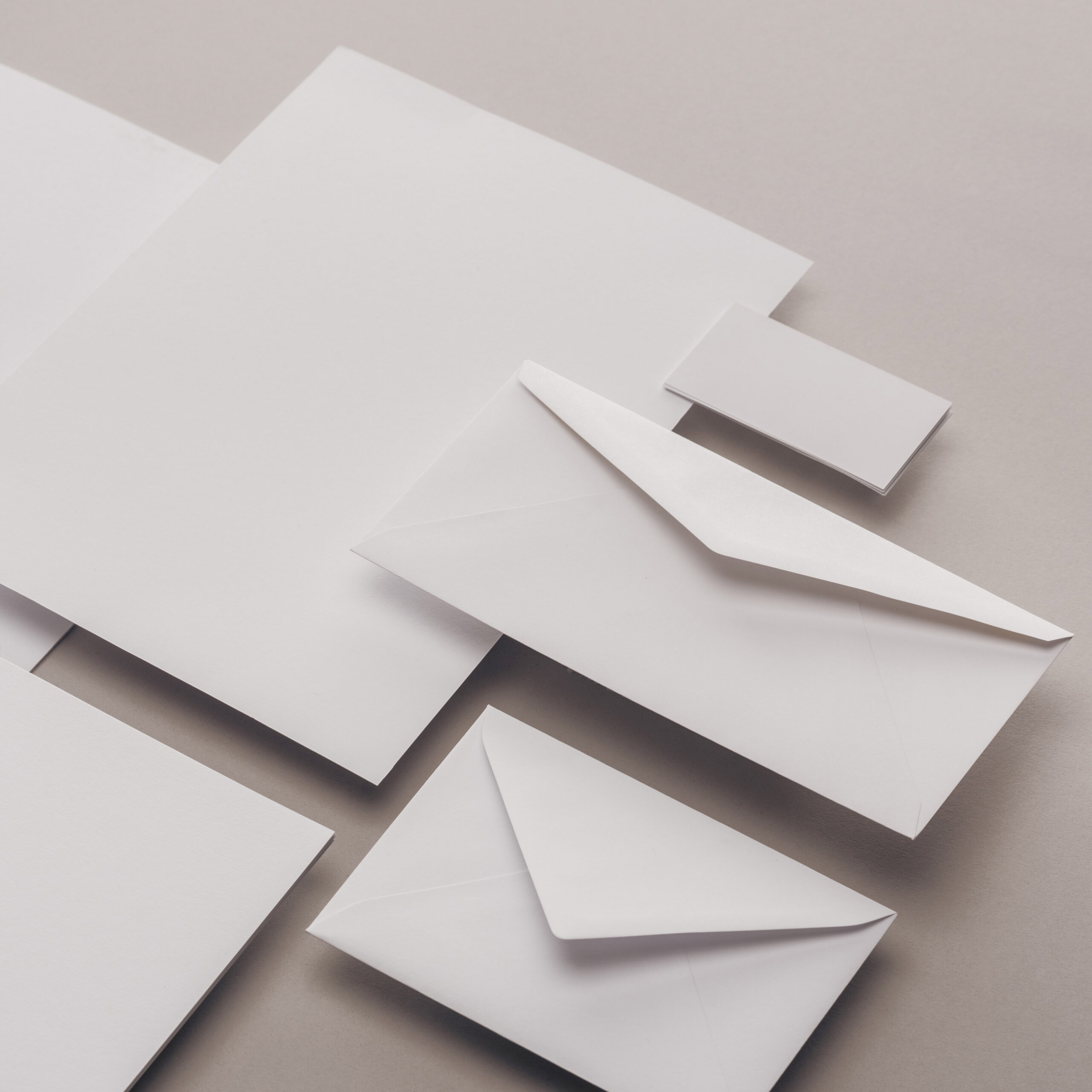 Flat lay with white papers and envelopes on grey background