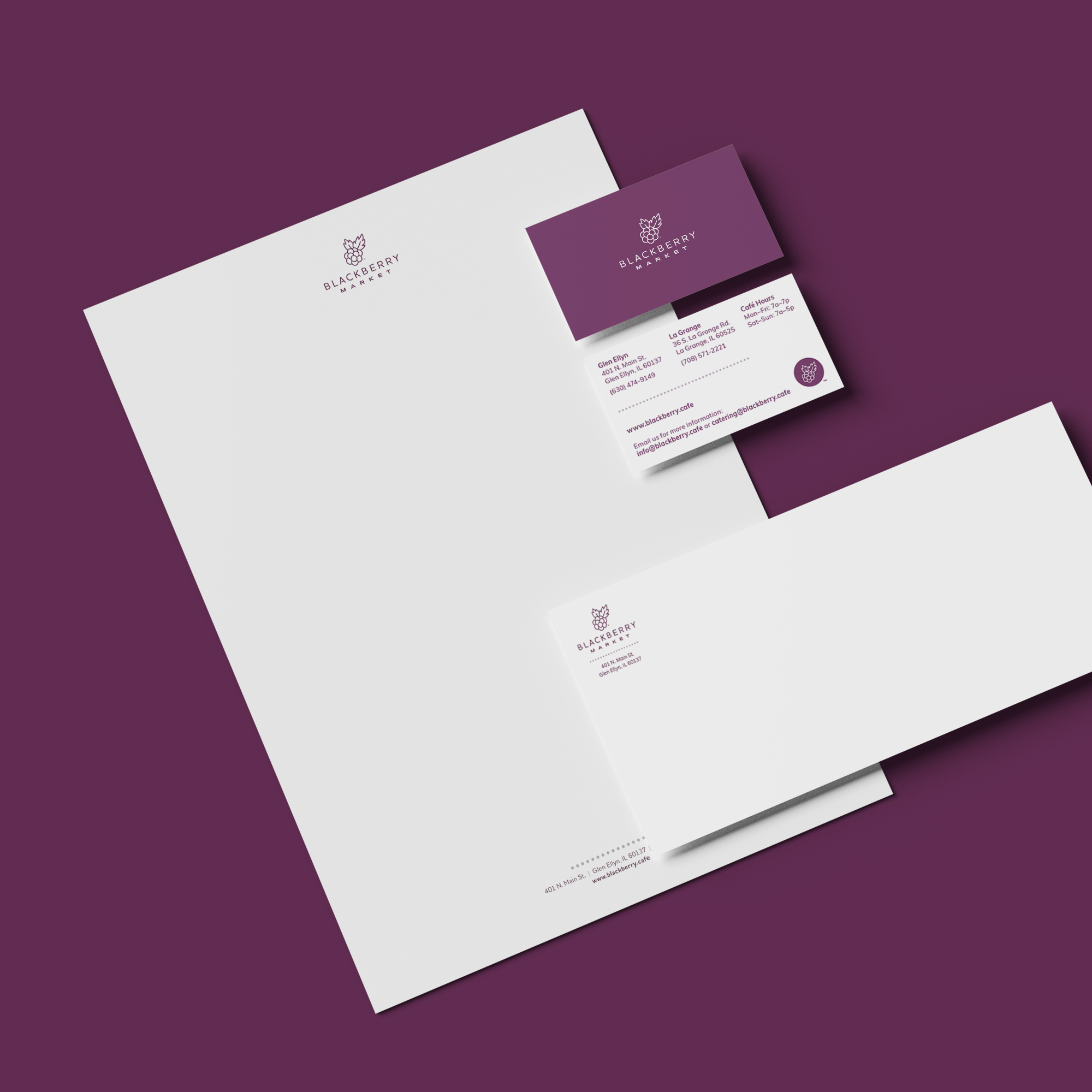 Blackberry Market stationery set of letterhead, business card, and envelope on a dark purple background