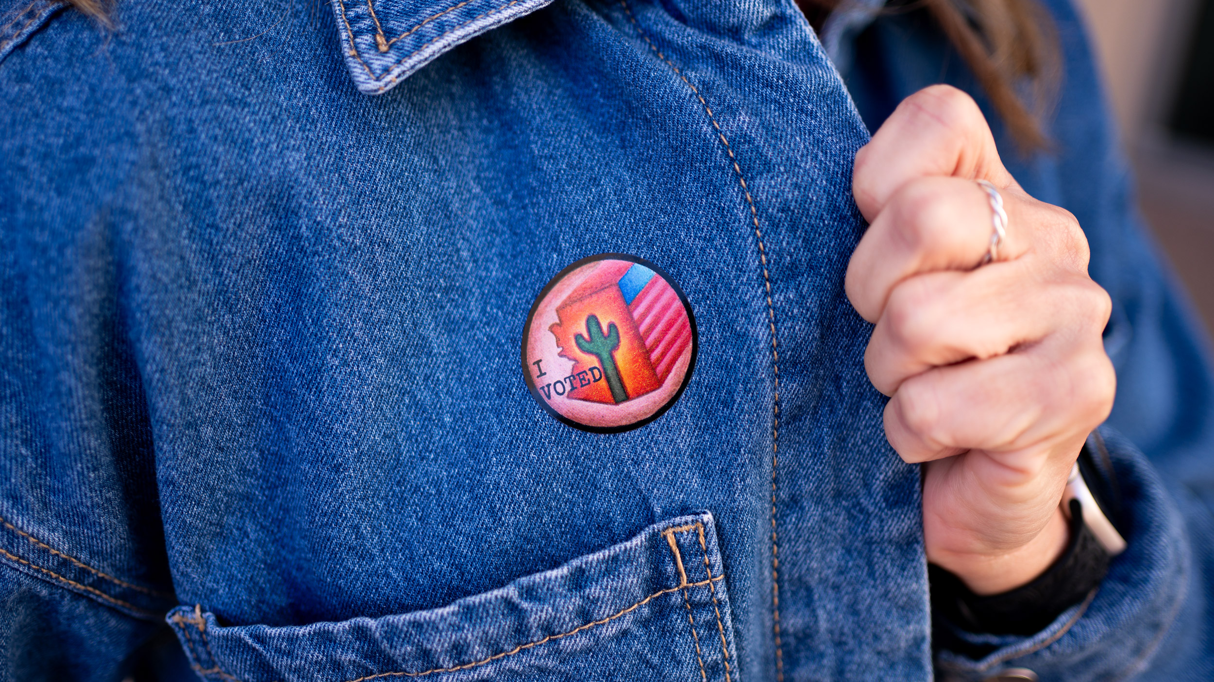 Vote sticker on jean jacket closeup
