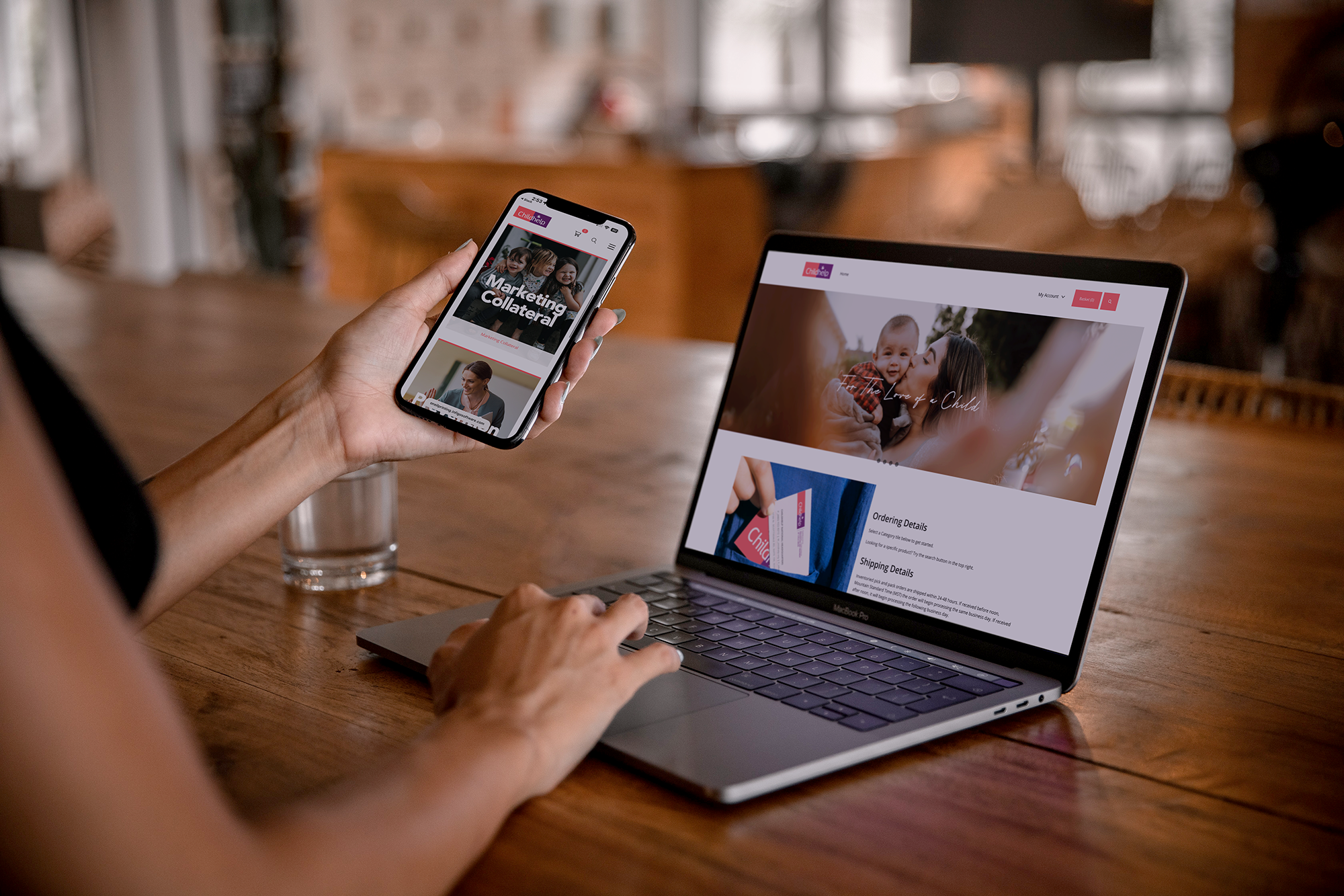 Close up of a woman looking at the storefront on both a laptop and mobile phone