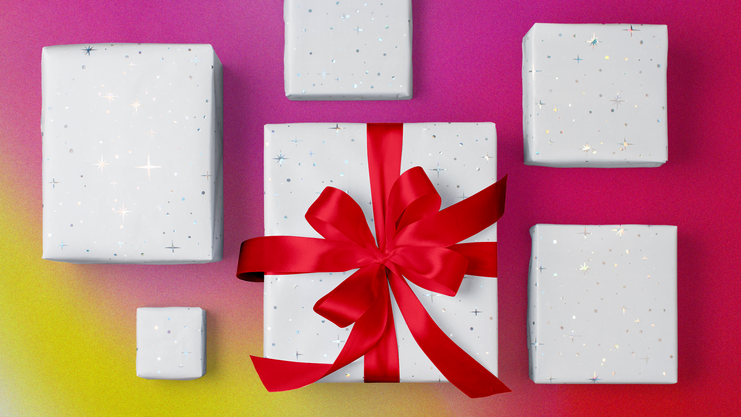 White giftboxes with red ribbon on a pink, red, and yellow gradient background